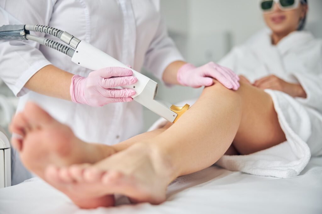 Doctor using a laser hair removal device